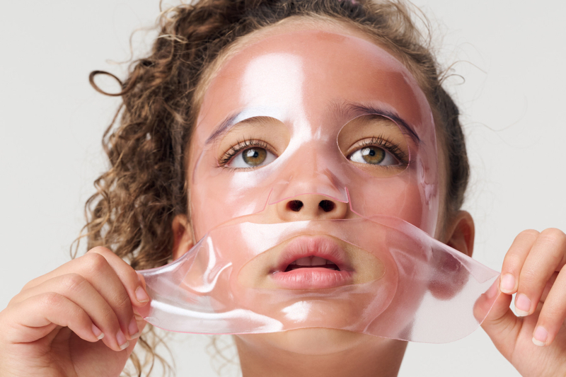 Young child wearing a clear skin care mask