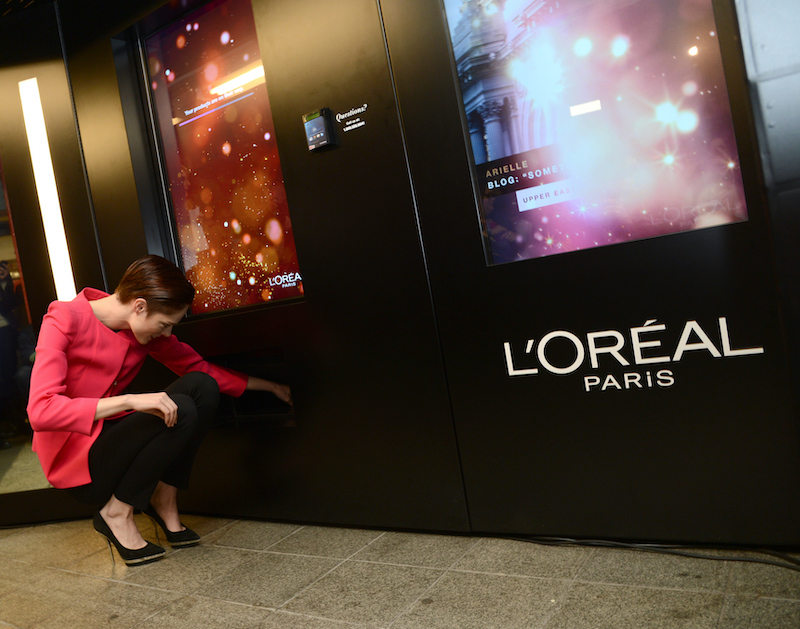 L'Oreal Paris introduces an interactive kiosk into the New York City Subway station, demonstrated by model Coco Rocha