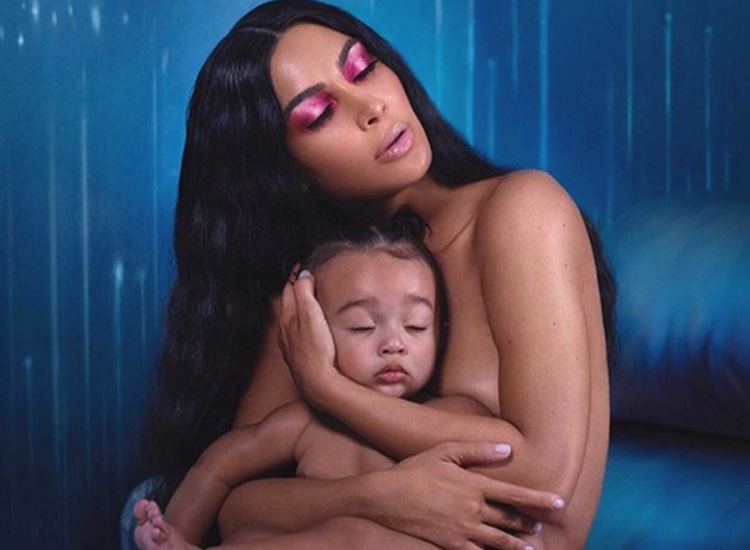 Kim Kardashian West poses with 9 month old Chicago for new KKW Beauty collection